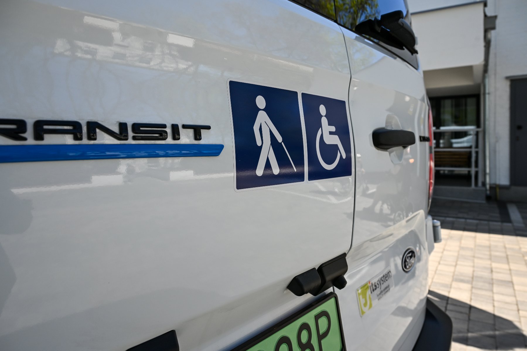 Na zdjęciu samochód z ikonogramami związanymi z osobami z niepełnosprawnościami