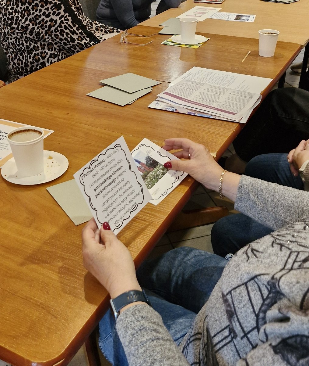Seniorka trzyma w ręku kartkę