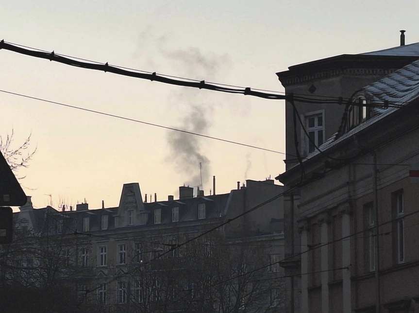 stare kamienice, z komina unosi się czarny, gęsty dym
