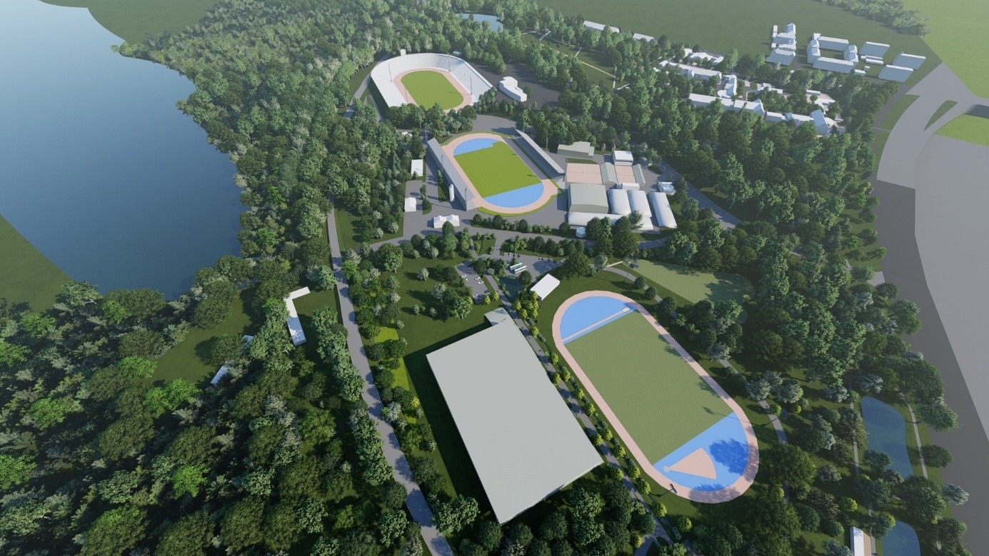 Wizualizacja architektoniczna przedstawiająca lotniczą perspektywę kompleksu sportowo-rekreacyjnego położonego w otoczeniu zieleni i zbiornika wodnego.