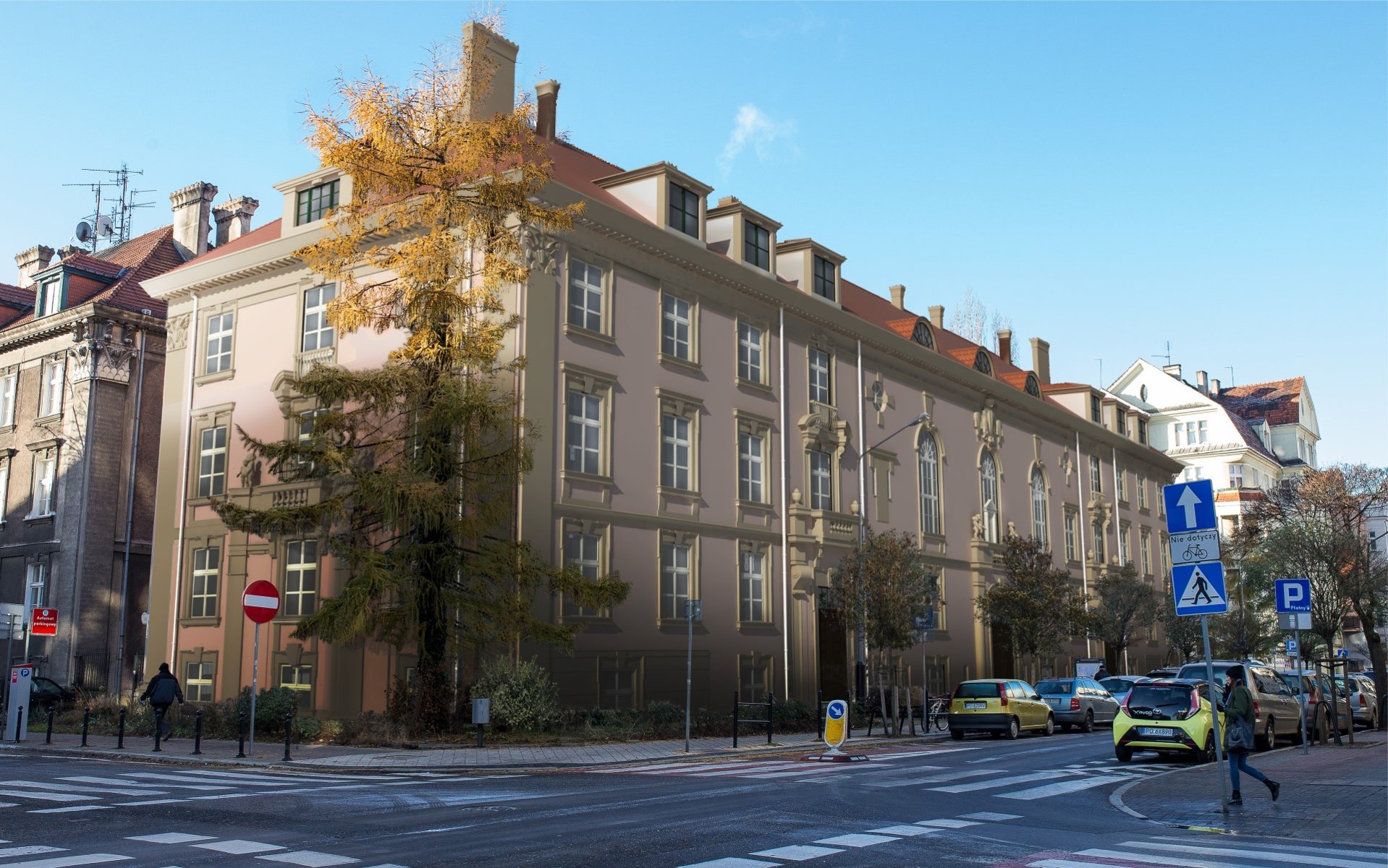 Zdjęcie odnowionego budynku. Obok znajduje się ulica, przy której widać zaparkowane samochody.